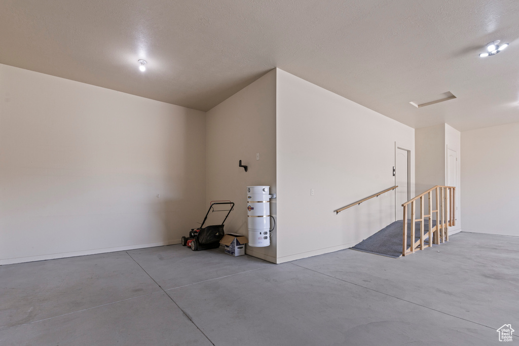 Spare room featuring finished concrete flooring and baseboards