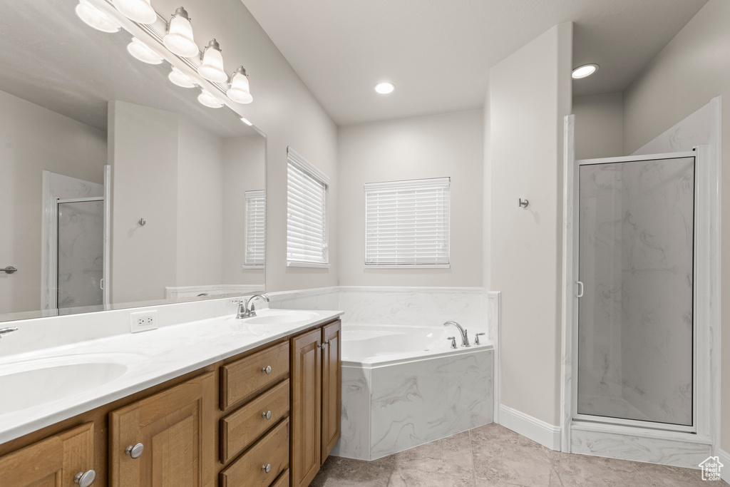 Full bath with a marble finish shower, a bath, double vanity, tile patterned floors, and recessed lighting