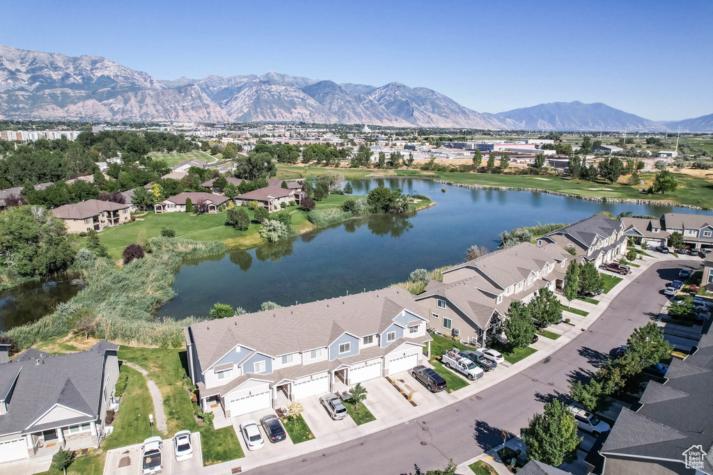 Aerial overview of property\'s location with a water and mountain view and nearby suburban area