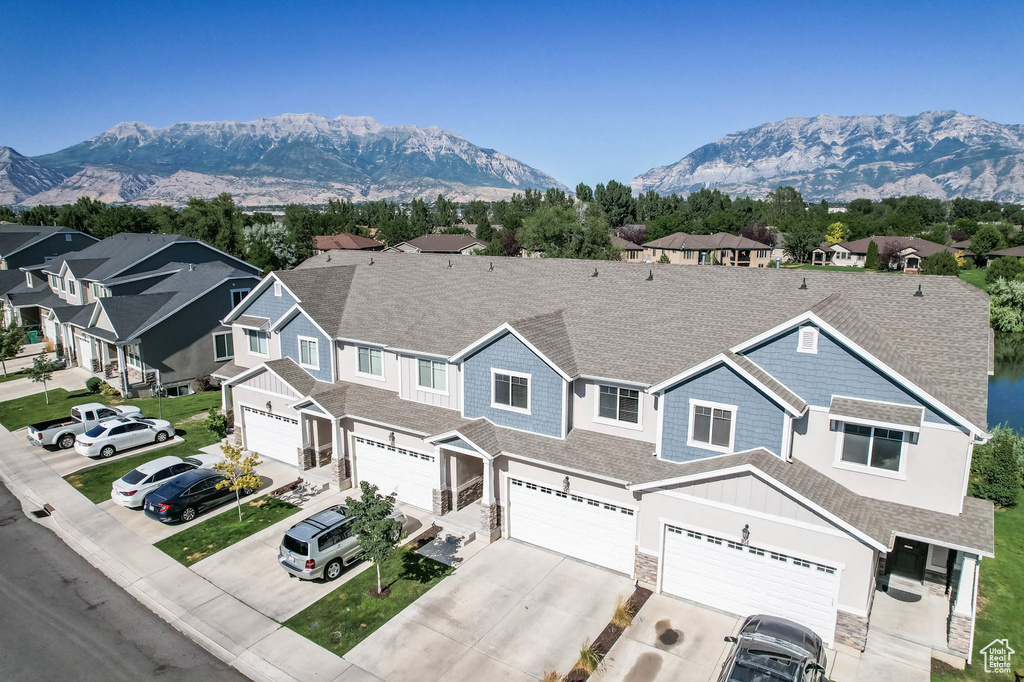 View of front facade featuring concrete driveway, an attached garage, and a mountain view