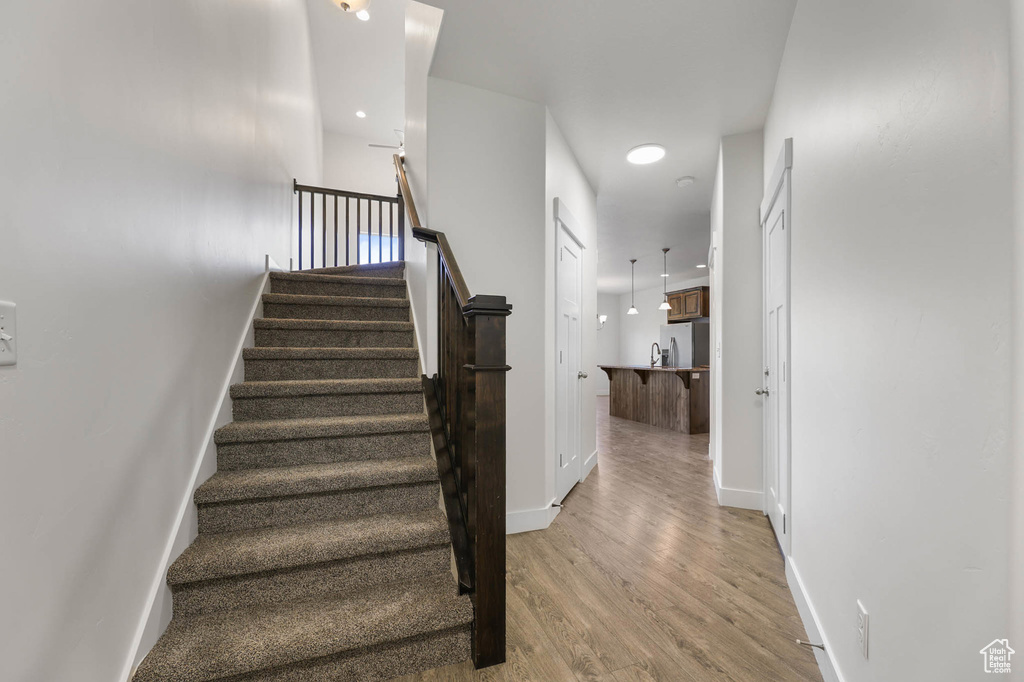 Stairway featuring wood finished floors and baseboards