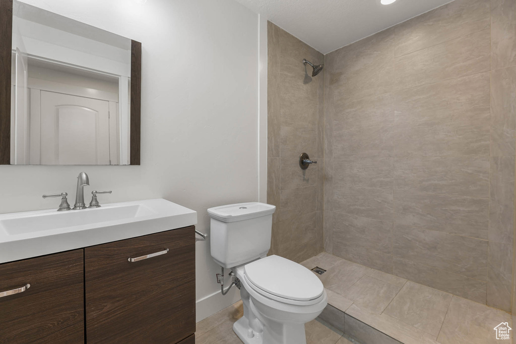 Bathroom featuring vanity and a tile shower