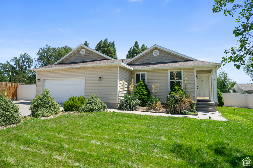 View of front of property with a garage and driveway
