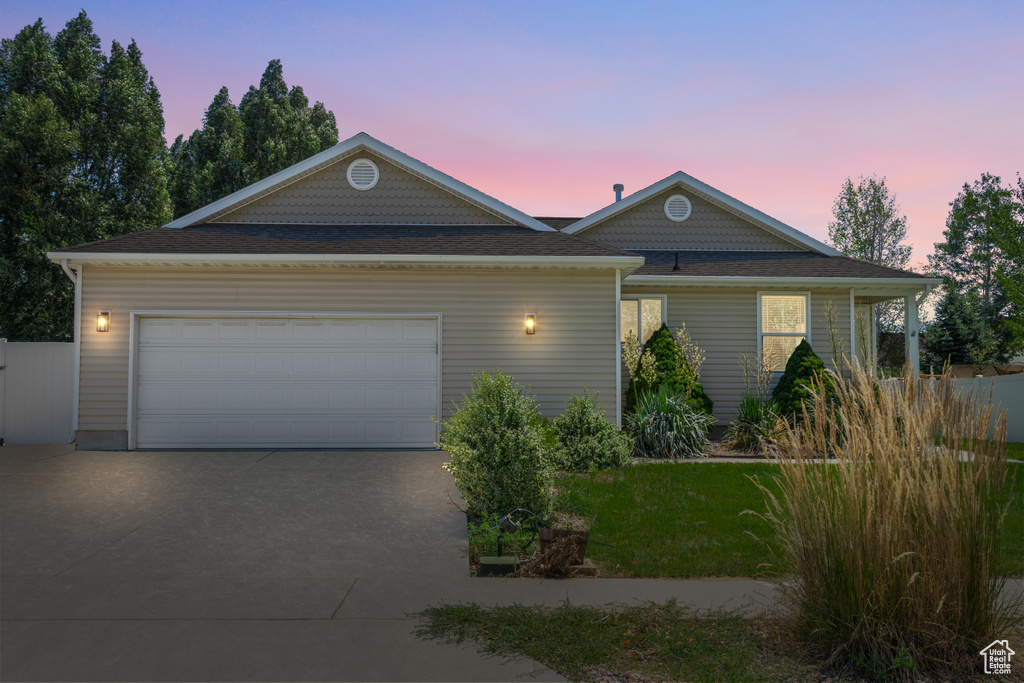 View of front of house featuring driveway and a garage
