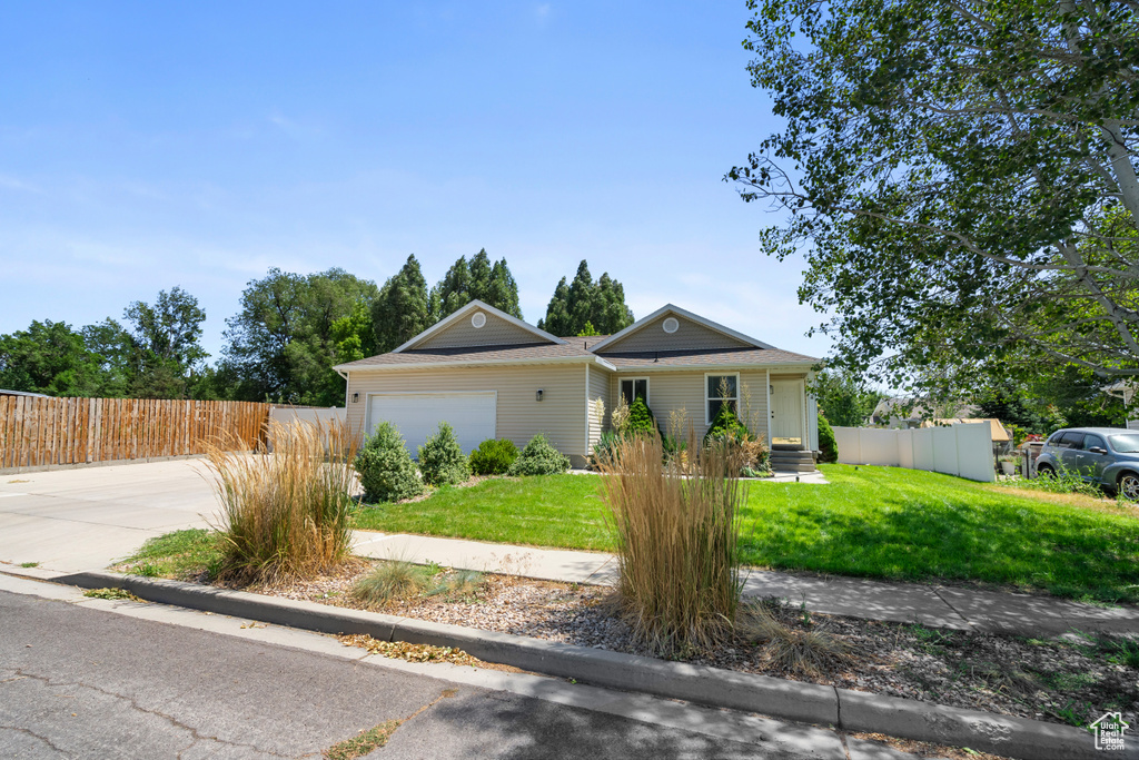 View of front of house featuring a garage and concrete driveway