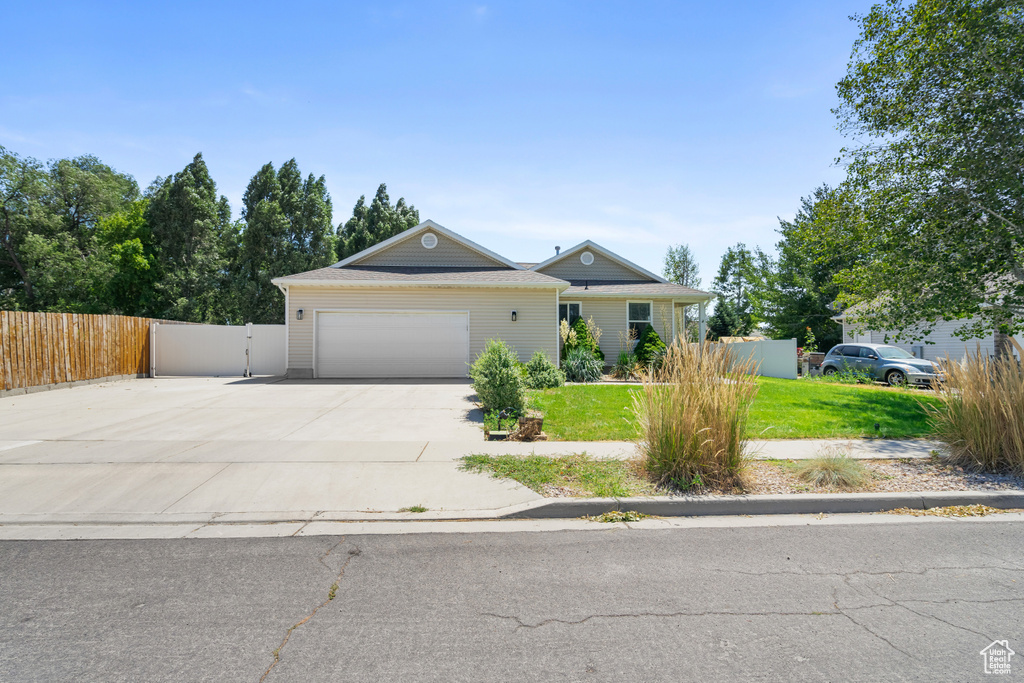 Ranch-style house with concrete driveway and an attached garage