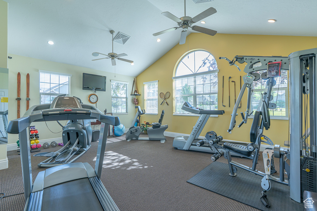 Exercise room featuring ceiling fan, lofted ceiling, and recessed lighting