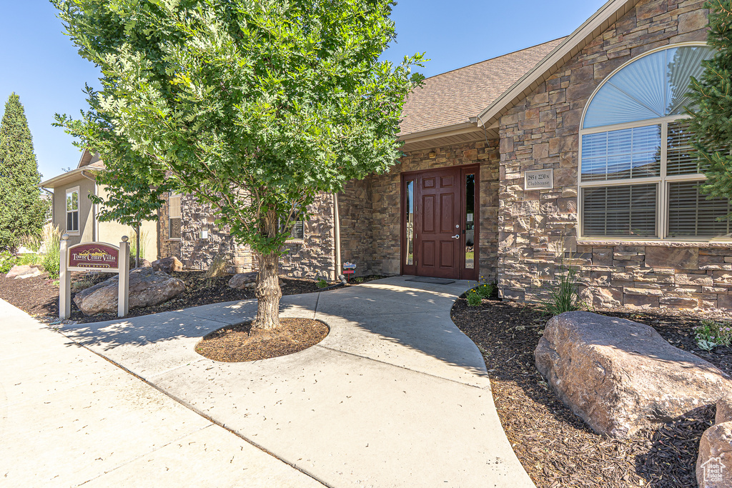 View of exterior entry featuring stone siding
