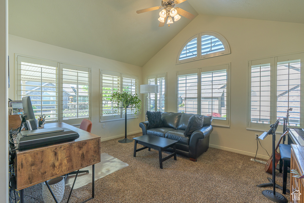 Living room featuring a ceiling fan, high vaulted ceiling, an office area, and carpet