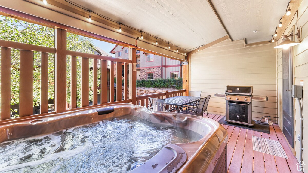 Deck featuring a grill and a hot tub