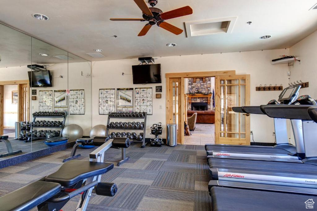 Workout area with a ceiling fan, carpet flooring, and recessed lighting