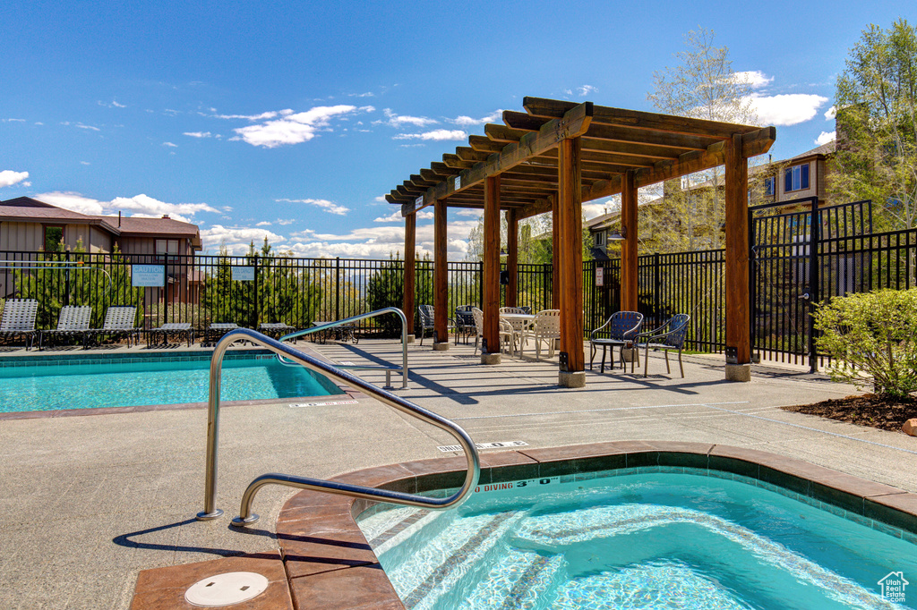 Outdoor pool with a patio and a community hot tub