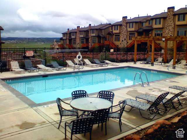 Community pool featuring a patio and a residential view
