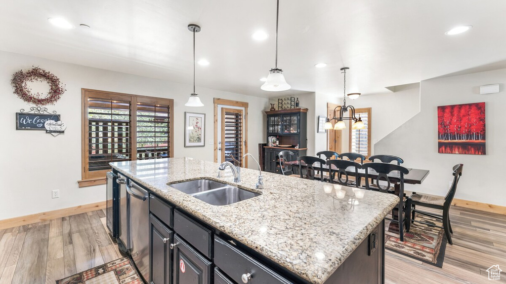 Kitchen featuring dishwasher, a kitchen island with sink, light wood-type flooring, healthy amount of natural light, and recessed lighting