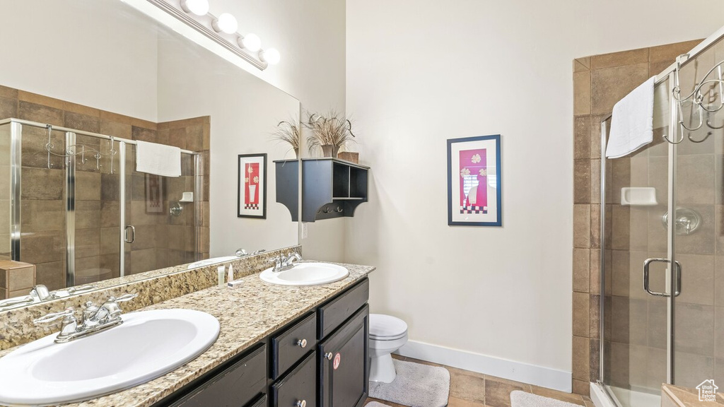 Full bathroom with double vanity and a stall shower