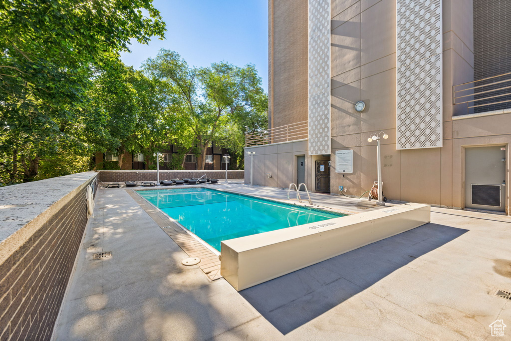 Community pool with a patio