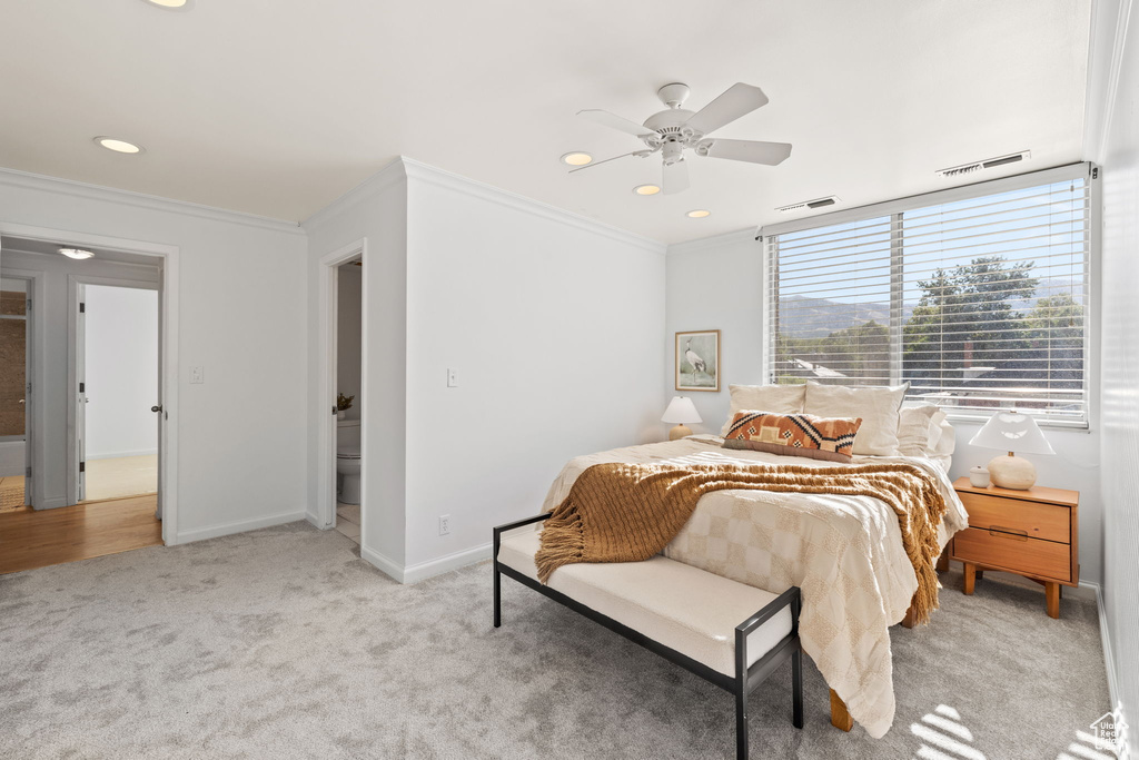 Bedroom with ornamental molding, light colored carpet, recessed lighting, and a ceiling fan