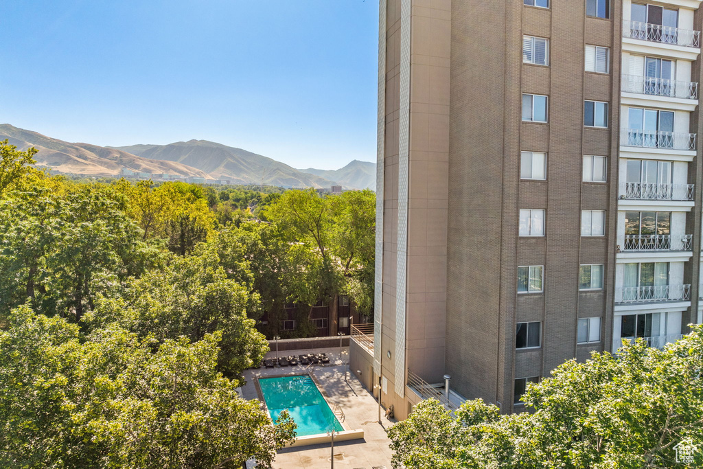 View of swimming pool with a mountain view