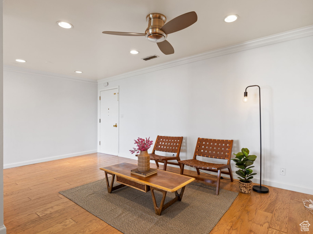 Sitting room featuring ceiling fan, ornamental molding, recessed lighting, and light wood finished floors