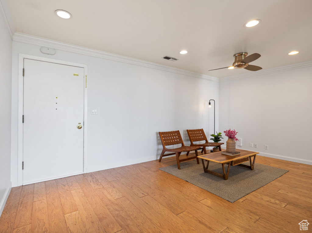 Sitting room with ornamental molding, a ceiling fan, light wood-style flooring, and recessed lighting