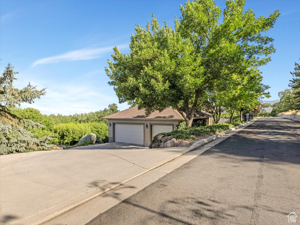 View of front of property featuring concrete driveway and a garage