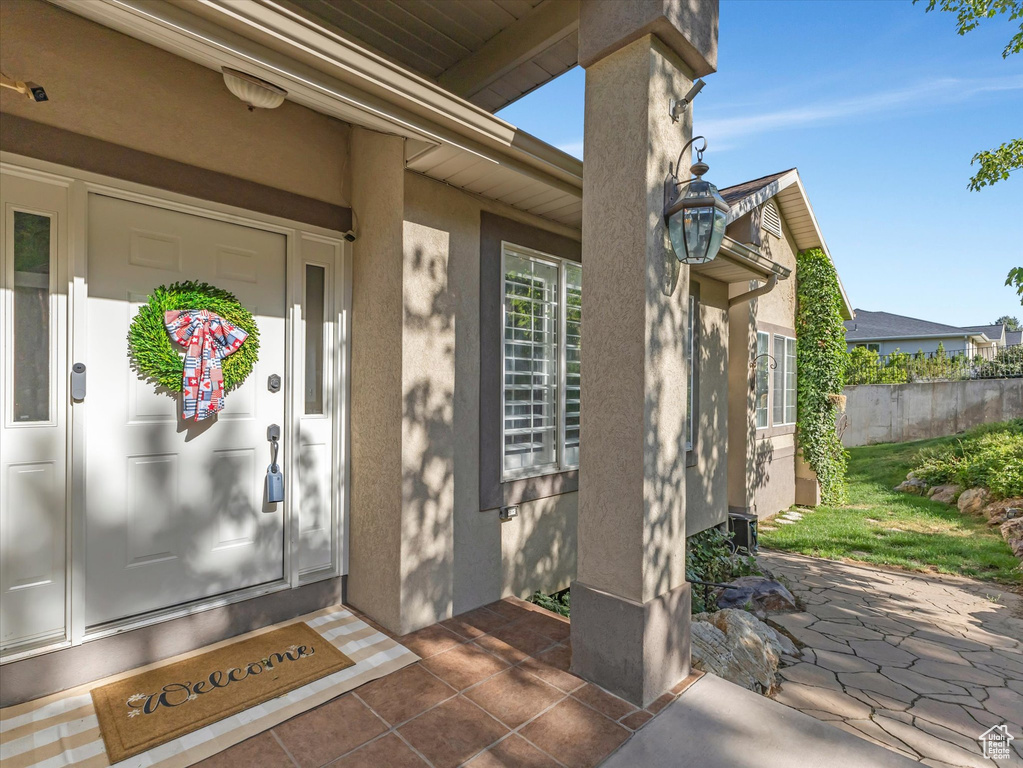 Entrance to property with stucco siding