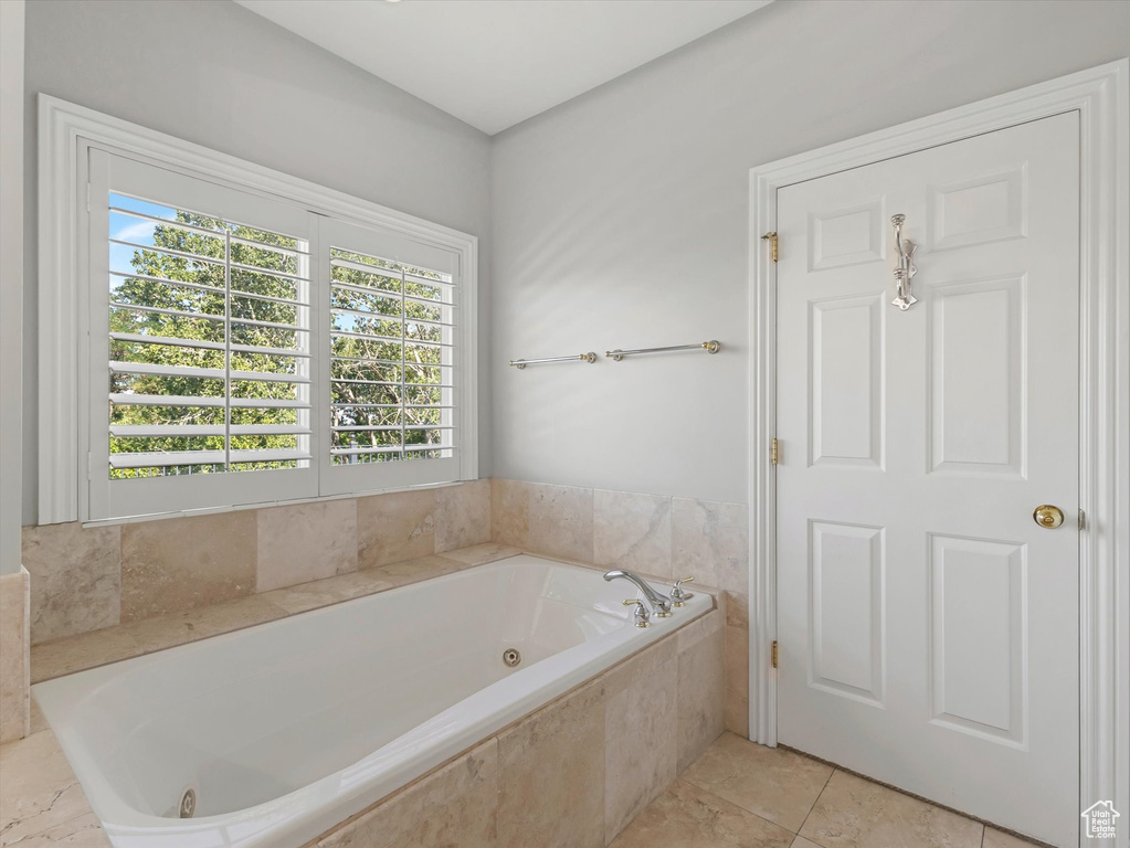 Full bath featuring a whirlpool tub and tile patterned floors