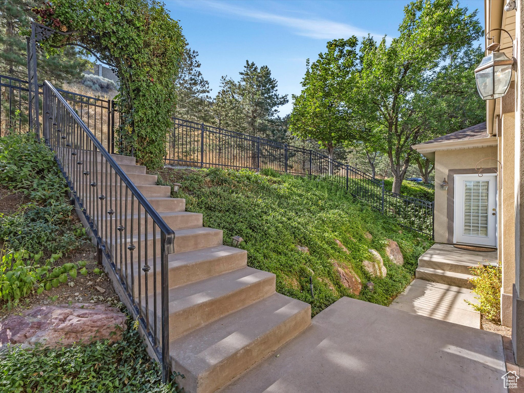 View of yard featuring stairway and a patio