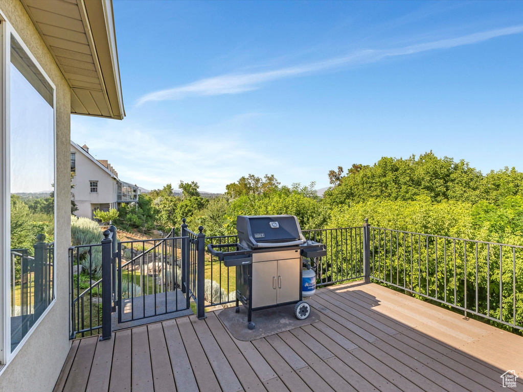 Wooden terrace featuring grilling area