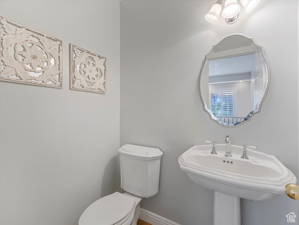 Bathroom with toilet and baseboards