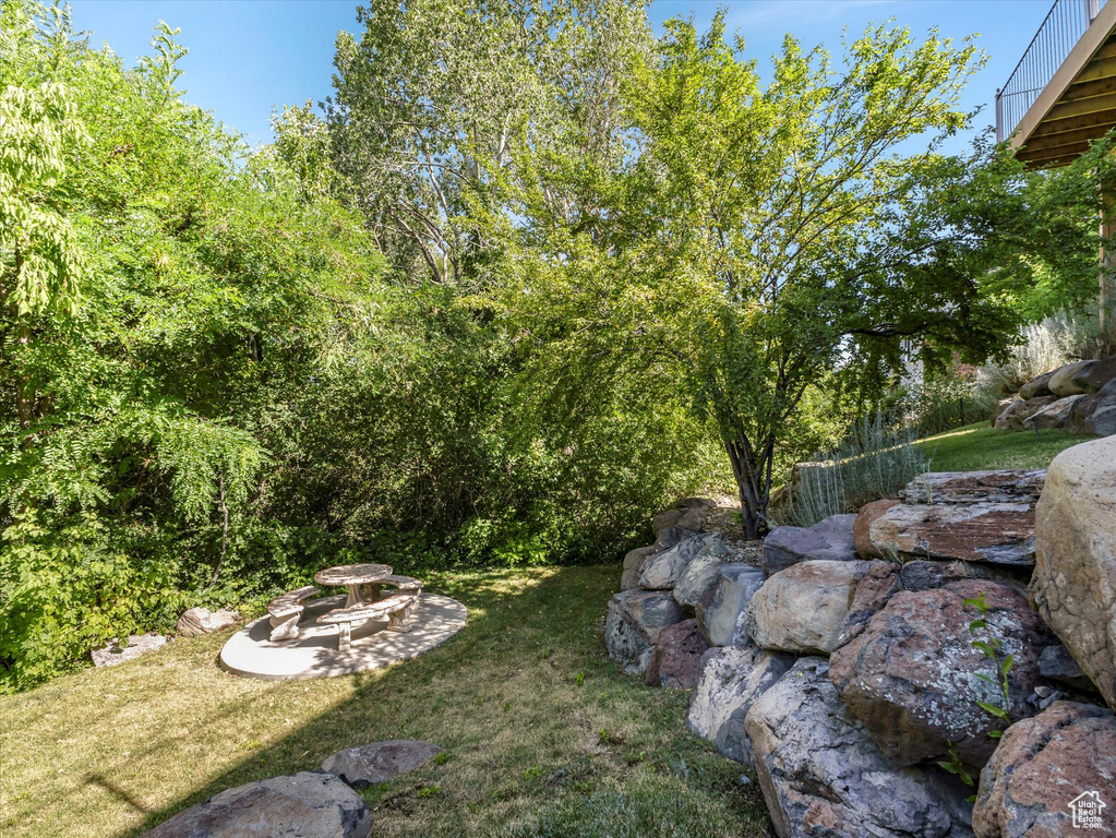 View of green lawn featuring a patio area