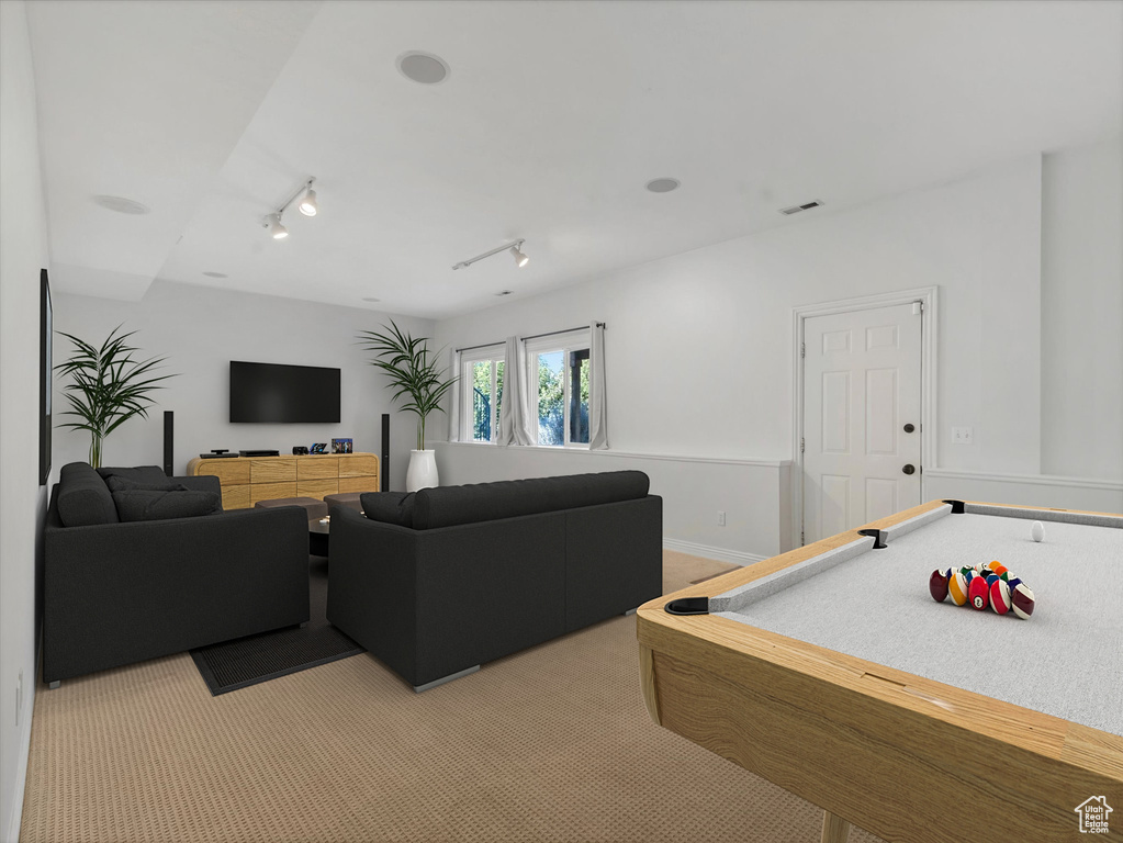 Playroom featuring light colored carpet and rail lighting