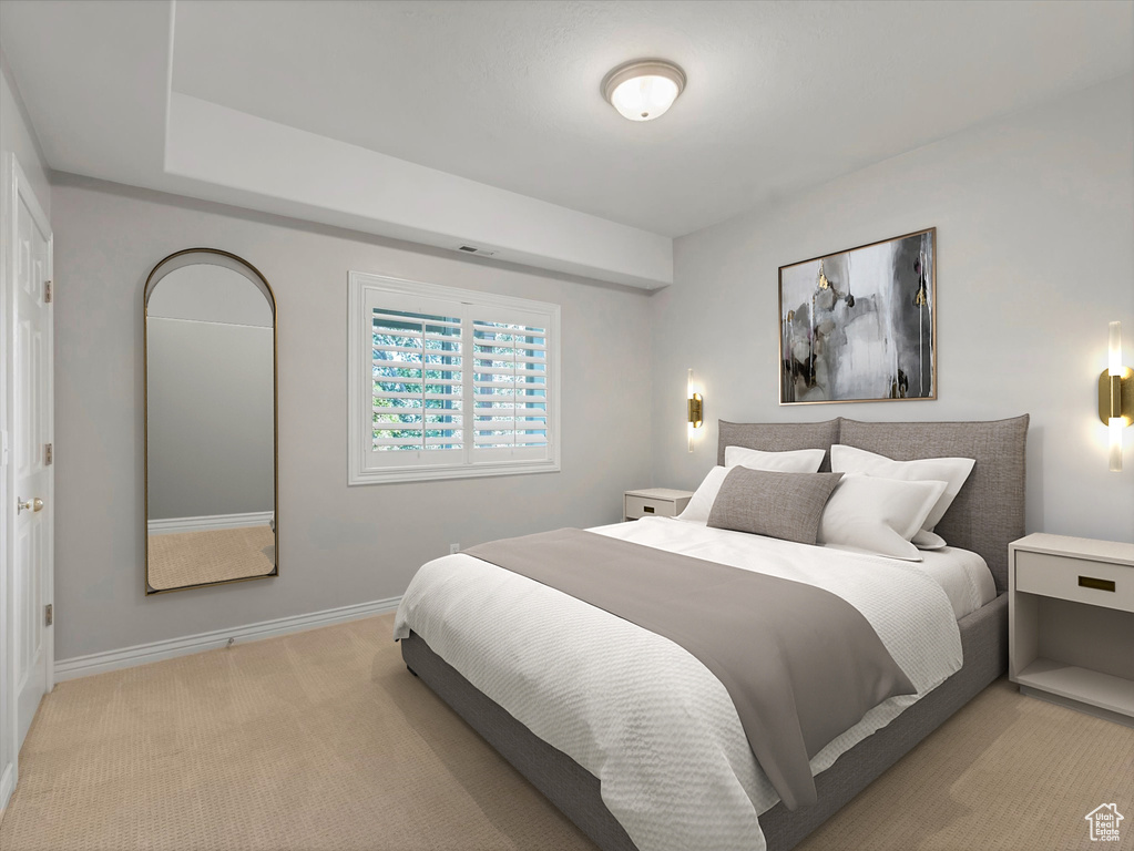 Bedroom featuring light carpet and baseboards