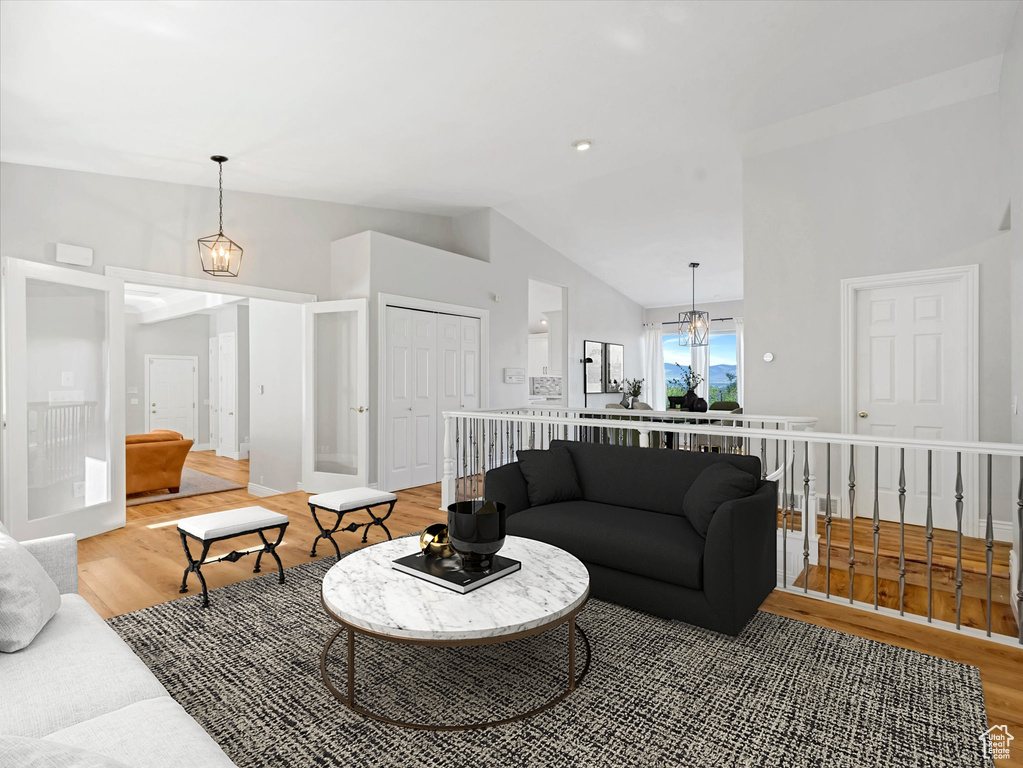 Living room with vaulted ceiling and light wood finished floors