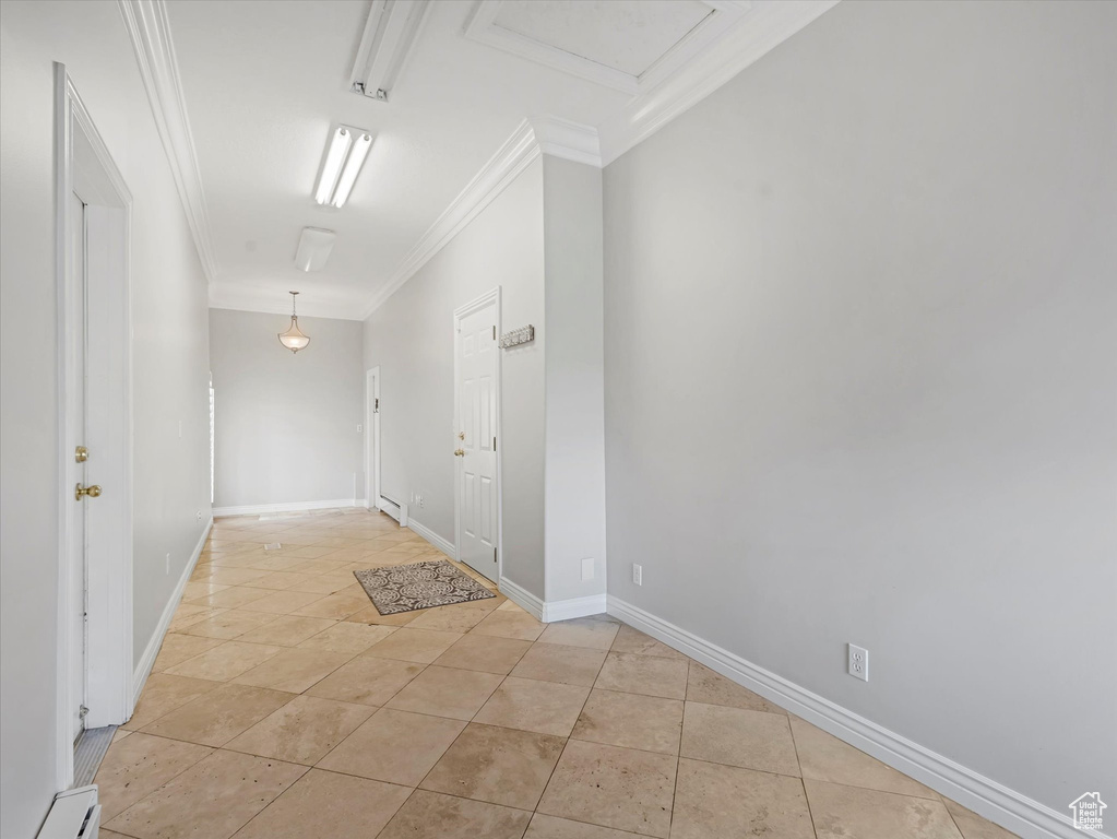 Hall with ornamental molding, light tile patterned floors, and baseboard heating