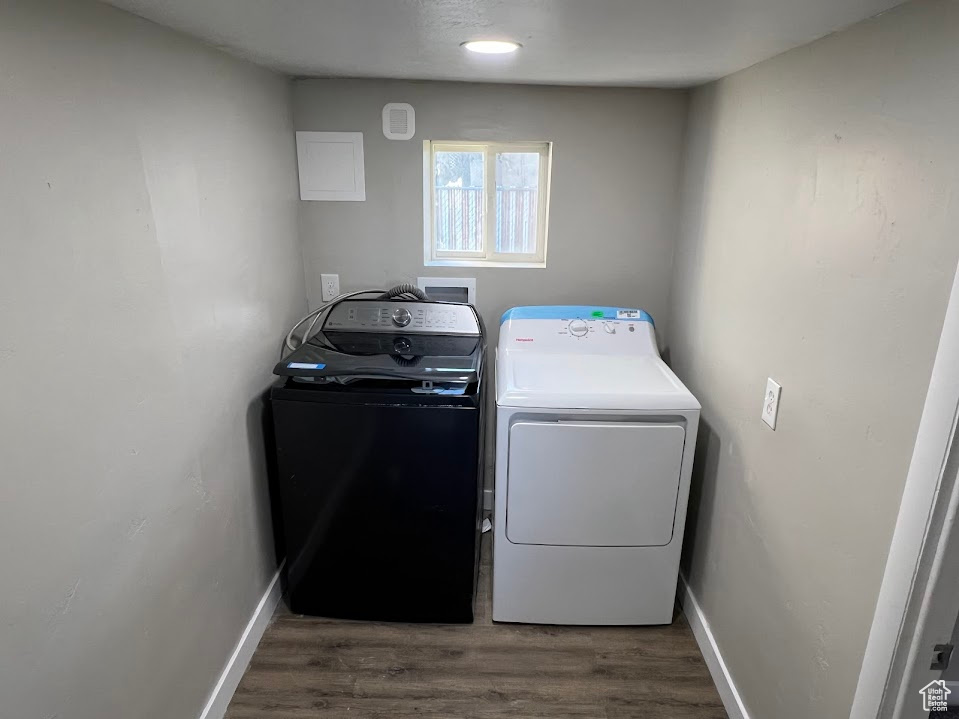 Laundry room featuring washer and clothes dryer and wood finished floors