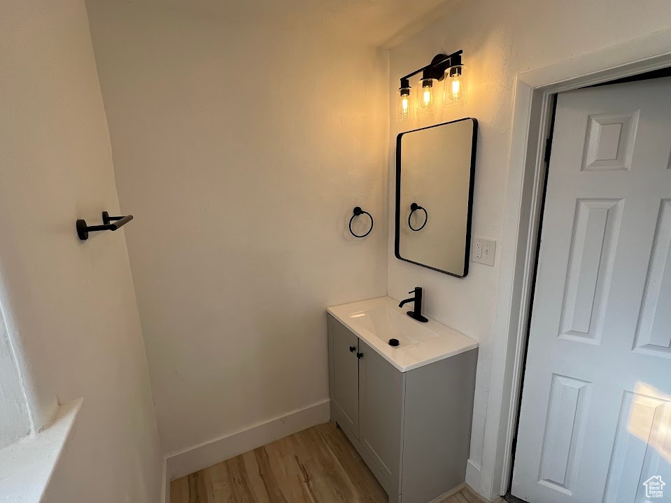 Bathroom with vanity and wood finished floors