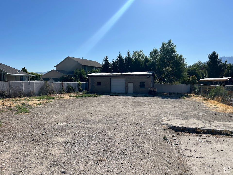 Back of property with a garage