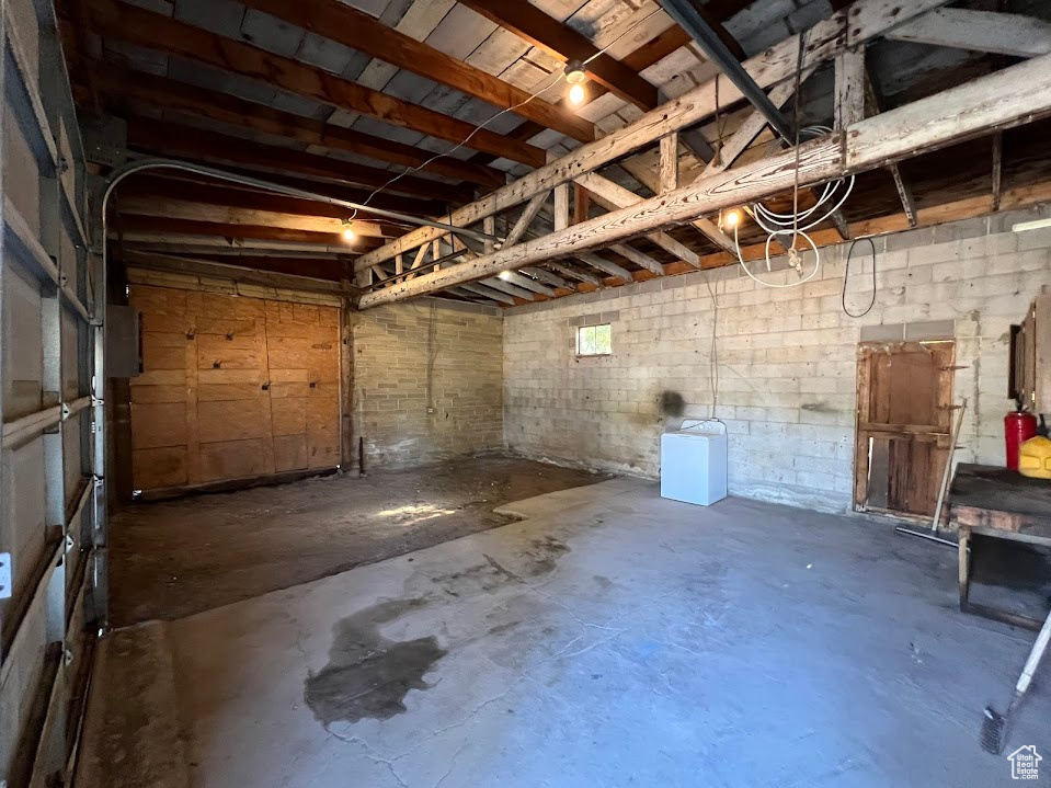 Garage featuring concrete block wall