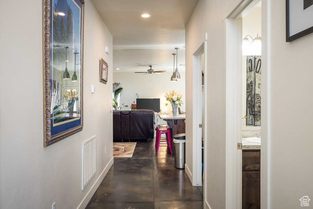 Hallway featuring concrete floors and recessed lighting