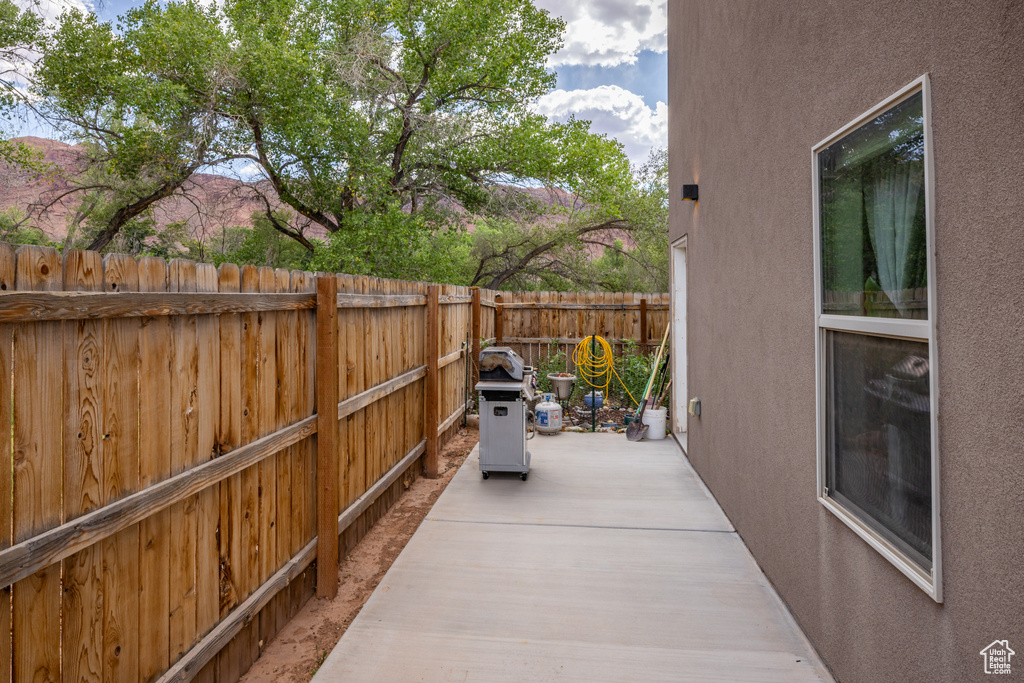 Fenced backyard with a patio area and grilling area