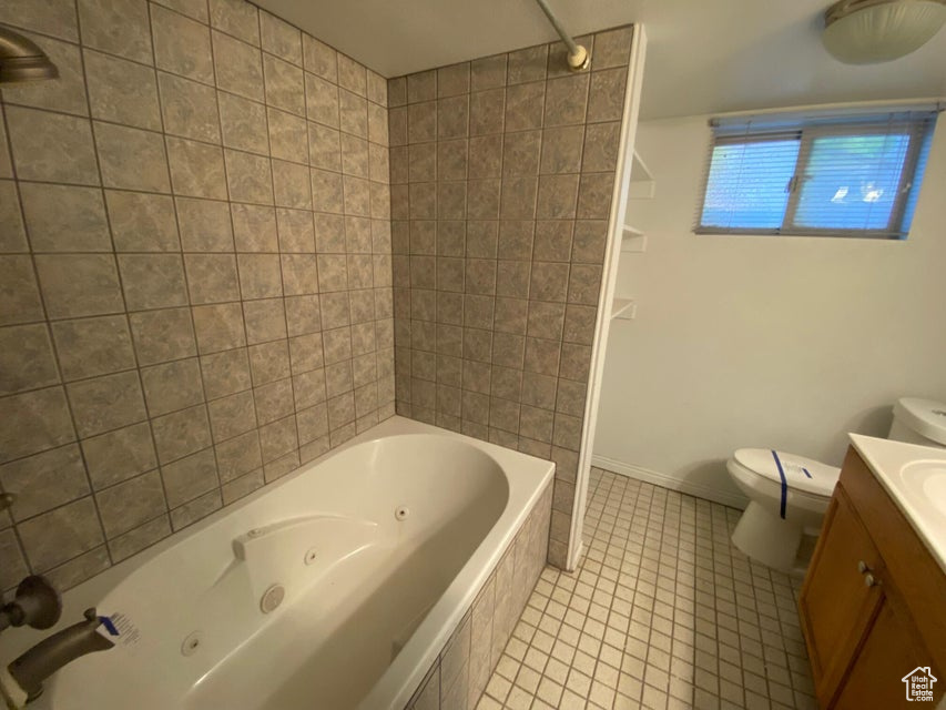 Full bathroom featuring vanity, tile patterned floors, and a combined bath / shower with jetted tub