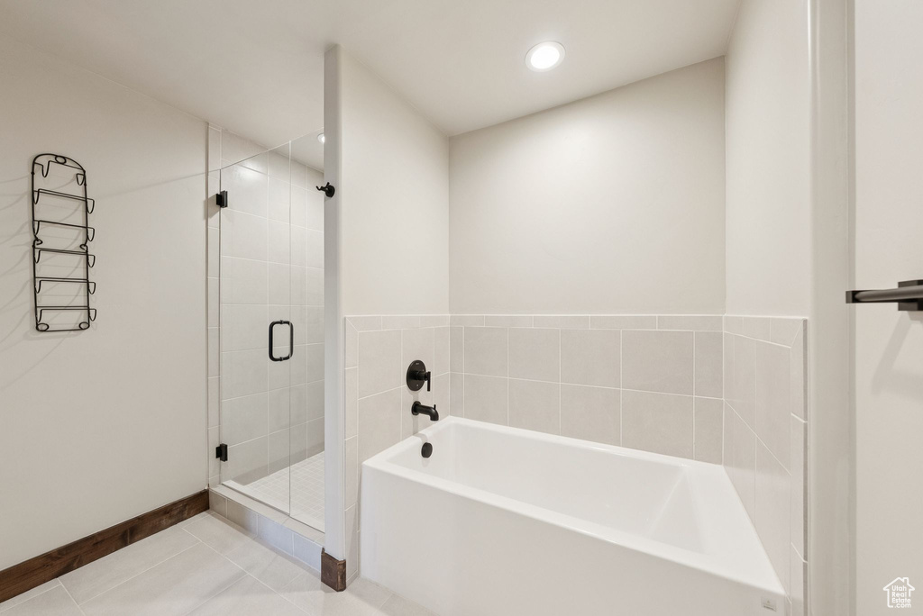 Bathroom with a bath, a stall shower, tile patterned flooring, and recessed lighting