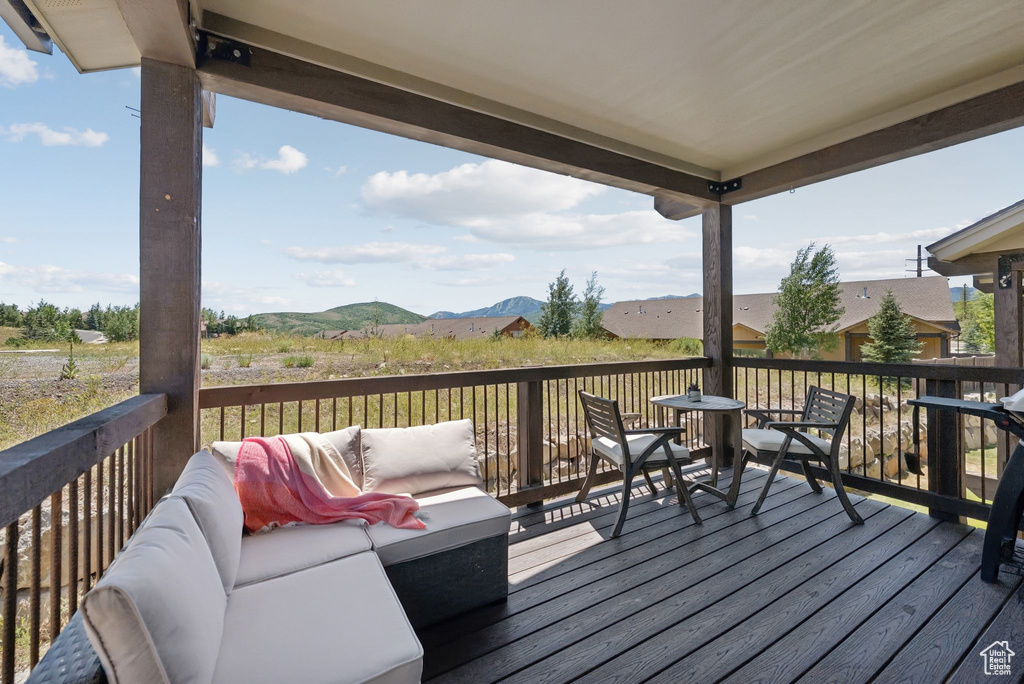 Deck with a mountain view and an outdoor hangout area