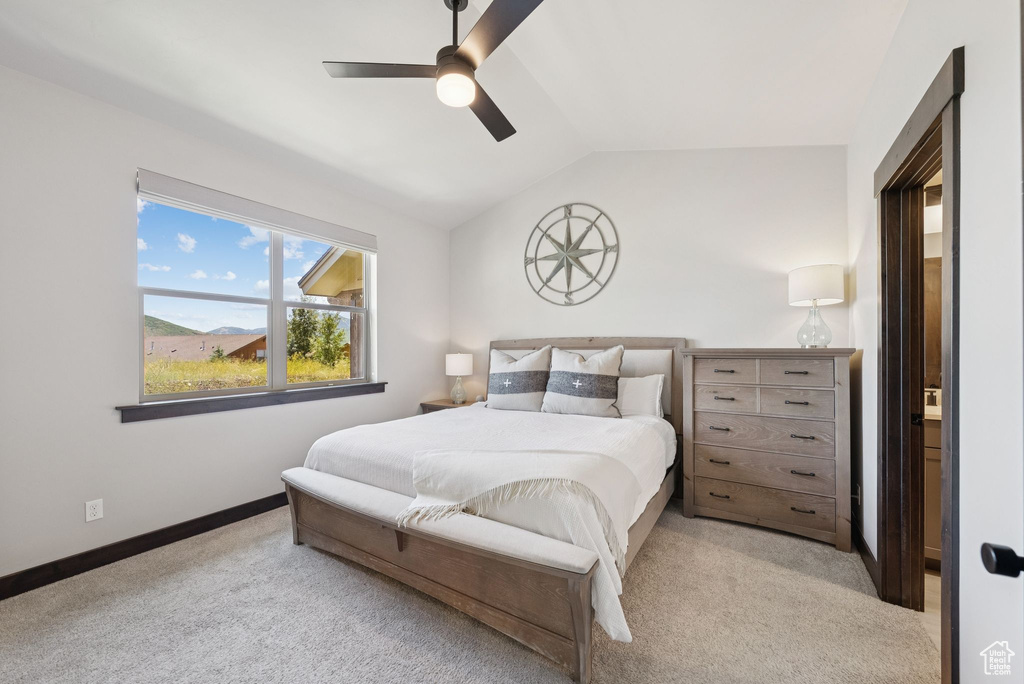 Bedroom featuring carpet flooring, lofted ceiling, and a ceiling fan