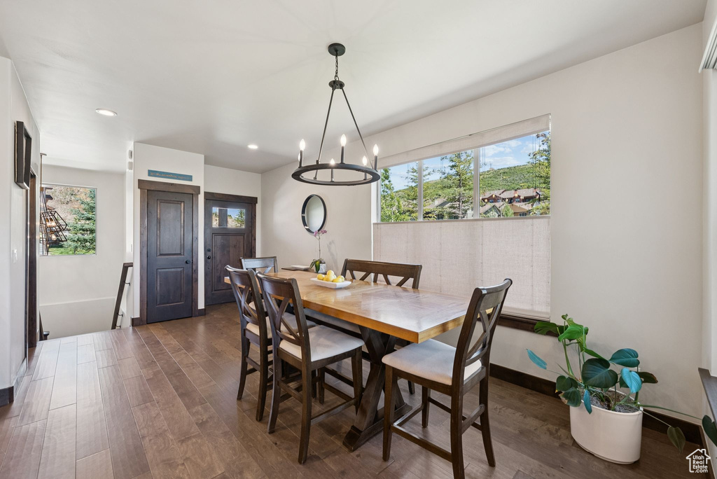 Dining area featuring dark wood-style flooring, a chandelier, and recessed lighting