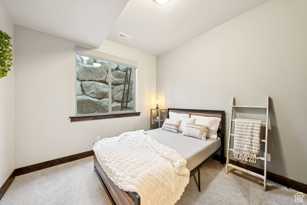 Carpeted bedroom with baseboards