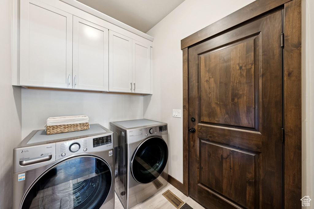 Laundry room featuring cabinet space and washing machine and dryer