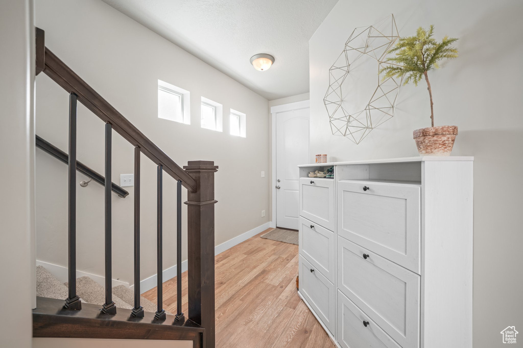 Entryway featuring light wood finished floors and stairs