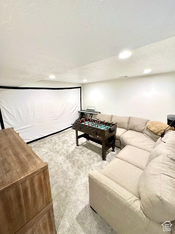 Carpeted living area featuring recessed lighting